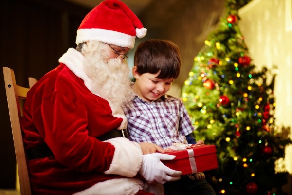Santa Claus dando a un niño su regalo de Navidad