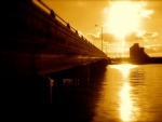 Puente iluminado por un sol dorado
