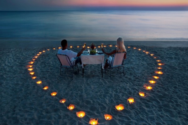 Pareja de enamorados cenando en la playa