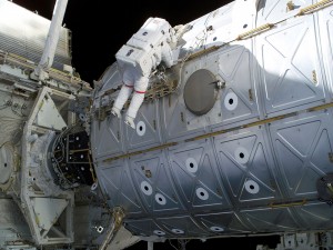 Astronauta realizando trabajos sobre un satélite