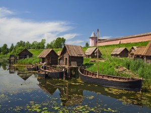 Postal: Barcas y casetas de madera en el río