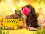 Nena con un conejito, junto a huevos de Pascua