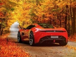 Aston Martin rojo en  la carretera