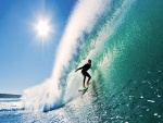 El brillo del sol sobre el surfista en la gran ola