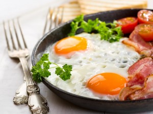 Huevos, tocino y tomate en un plato