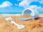 Cubo, pala y una cometa para jugar en la playa