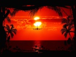 Avión atravesando el mar frente al ocaso del sol