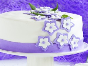 Una bonita tarta cubierta de fondant con pequeñas flores
