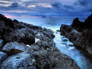 Postal: Rocas en la costa vistas al atardecer
