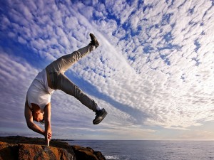 Hombre realizando ejercicios de equilibrio junto al mar