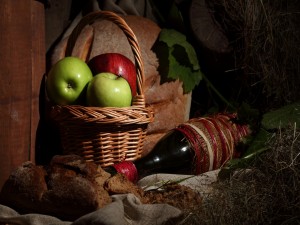 Botella de vino, pan y manzanas