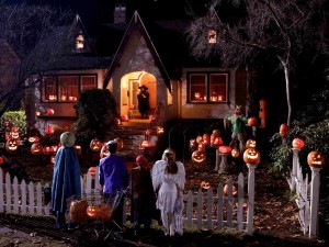 Postal: Niños junto a una casa en la noche de Halloween