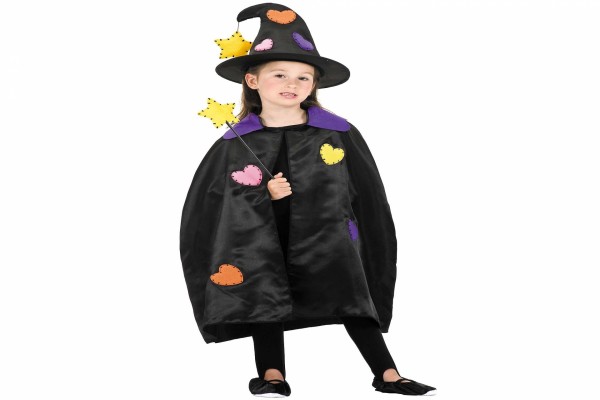 Niña con un disfraz de bruja para Halloween