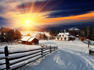 Postal: Pueblo cubierto de nieve en un soleado amanecer