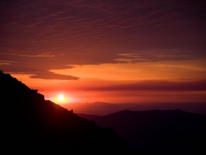 Postal: Un bello cielo al atardecer sobre grandes montañas