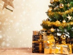 Regalos con cintas doradas junto a un árbol de Navidad