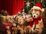 Una familia de osos de peluches junto al árbol de Navidad