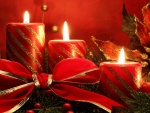 Velas rojas con un gran moño para celebrar las fiestas de Navidad