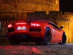 Lamborghini rojo con las luces traseras encendidas