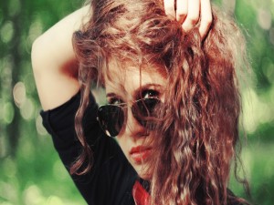 Postal: Chica con el pelo rizado y gafas de sol