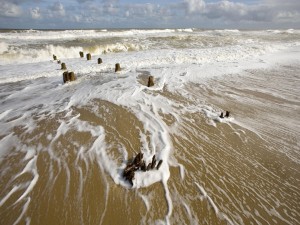 Postal: Restos de un muelle de madera en una playa