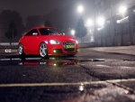 Audi TT rojo en un parking iluminado