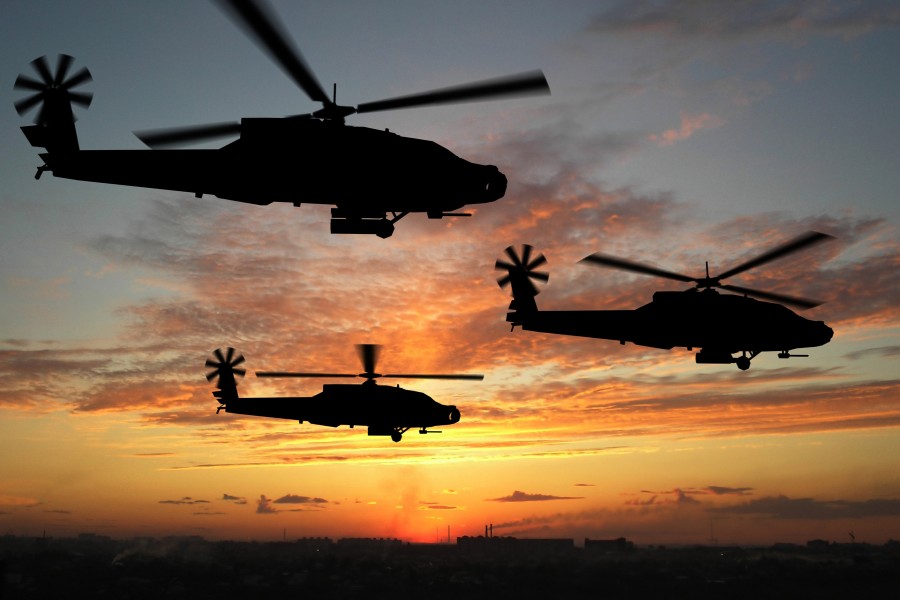 Helicópteros militares sobre una ciudad al amanecer