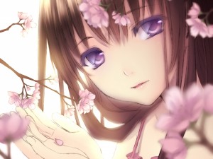 Hermosa chica tocando las flores de un cerezo