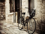 Bicicleta apoyada en una pared de piedra