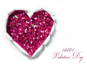 Feliz Día de San Valentín junto a un corazón de lentejuelas rosas