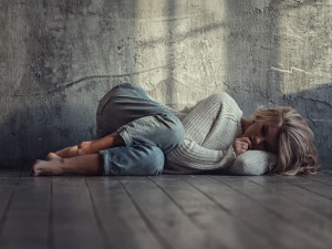 Mujer triste tumbada en el suelo