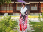 Mujer japonesa con un kimono de flores y una sombrilla