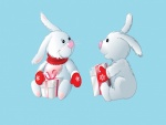 Conejos con manoplas rojas y regalos
